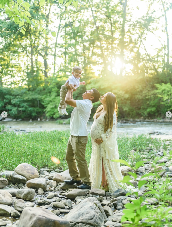 Sofi and her family beside a wooded creek